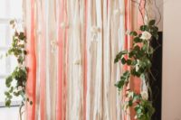 15 a pink and cream ribbon backdrop with some fresh greenery and white blooms on the sides