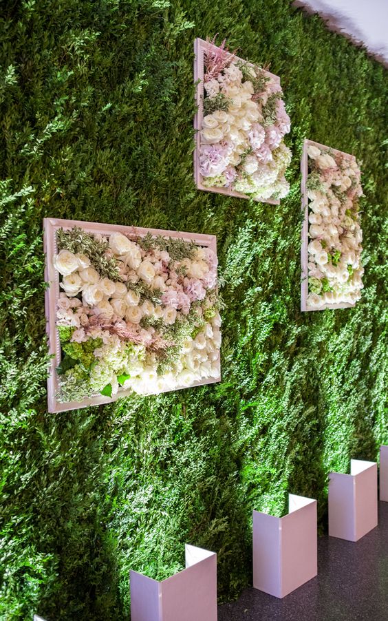 a living wall with frames filled with lush blooms to make a romantic statement