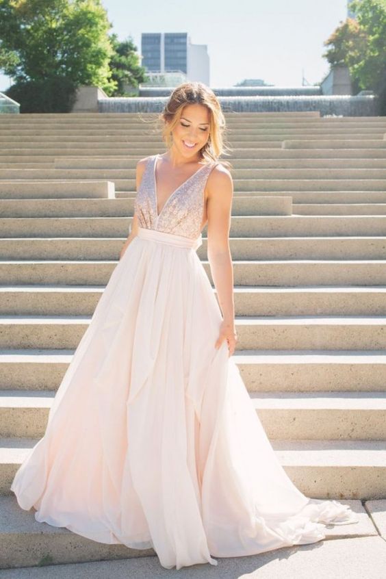 a sleeveless blush wedding gown with a sequin bodice and a plain full skirt, a plunging neckline