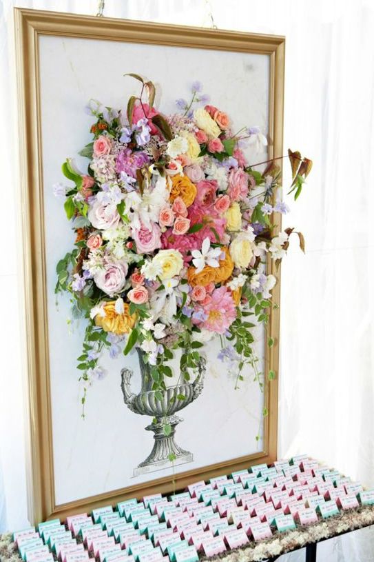 a gilded frame with an artwork completed with fresh blooms looks really wow