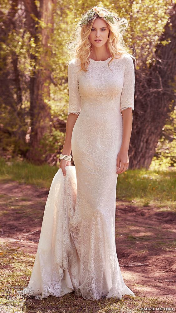 a modest lace wedding dress with half sleeves and a long train