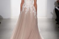 17 a sleeveless blush wedding dress with white lace appliques on the waist line and a train