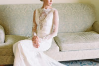 17 long sleeve lace wedding dress with an illusion plunging neckline and a long train