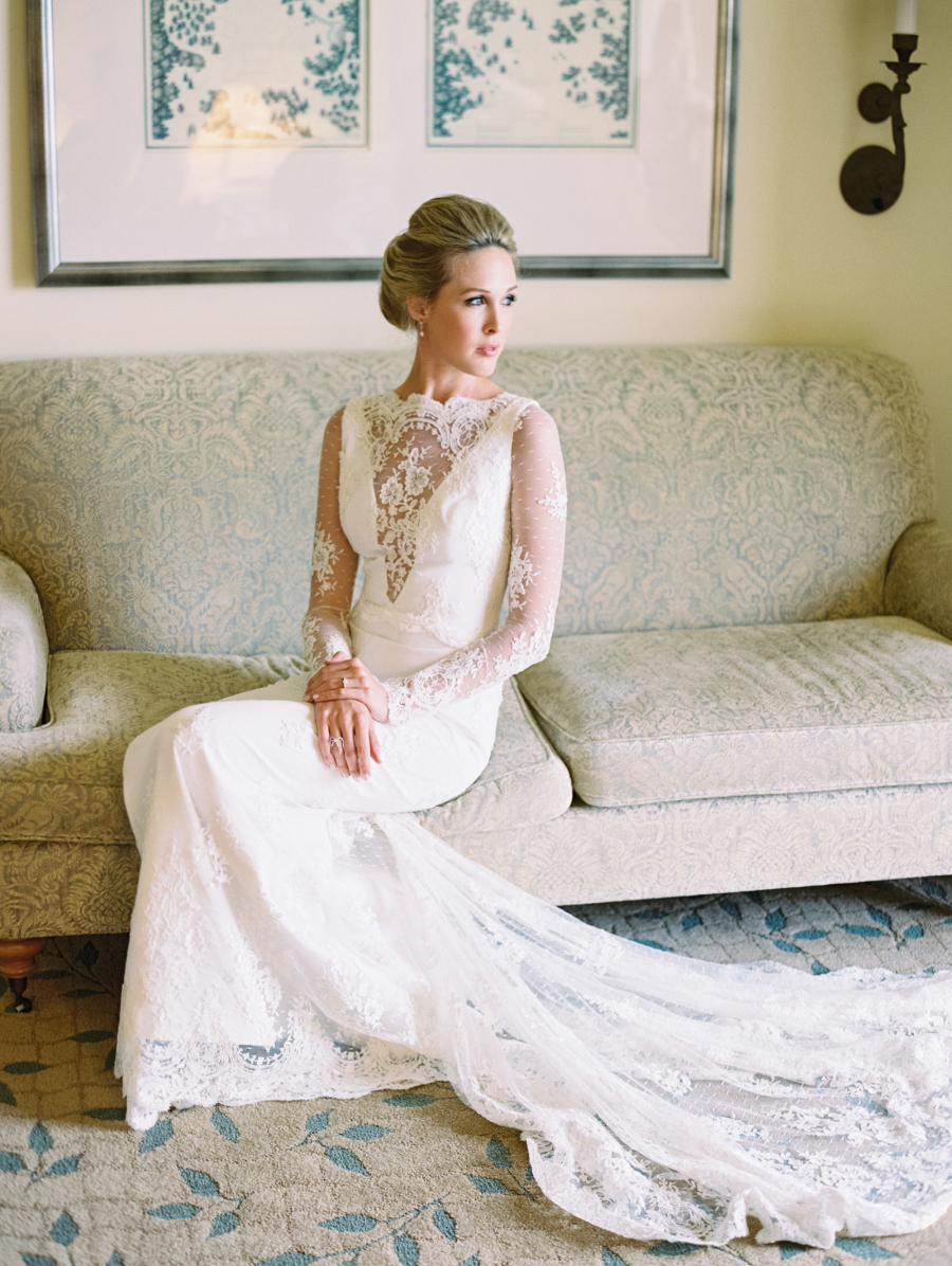 Long sleeve lace wedding dress with an illusion plunging neckline and a long train