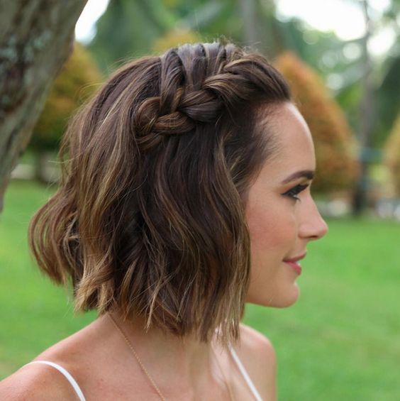 short wavy hair with a large braid on top is useful for a casual or boho wedding