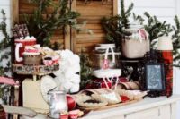 19 a hot cocoa bar with a vintage dresser, fir branches, plaid touches and lots of various candies
