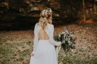 21 a boho wedding dress with a lace bodice, long sleeves and a cutout back, a plain skirt