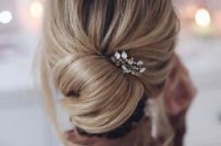 21 a casual messy updo with a twisted chignon and a rhinestone hairpiece to accentuate it