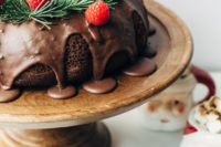 21 a chocolate wreath cake with chocolate drip, evergreens and raspberries
