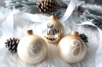 21 hand lettered gold glass ornaments can become nice favors for a winter wedding