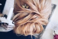 22 a casual twisted updo with a double chignon and a rhinestone hairpiece for an accent