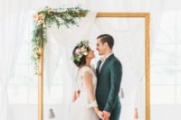 22 an ethereal draped fabric backdrop, an oversized picture frame decorated with greenery and blooms