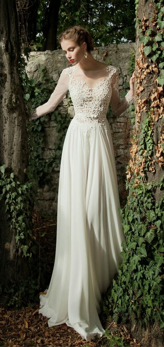 a chic ivory wedding dress with an illusion neckline, long sleeves and a textural lace bodice, a plain skirt