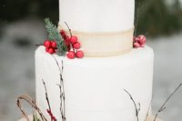 23 a chic wedding cake with berries, pinecones, evergreens and burlap ribbon