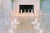 23 a faux fireplace lushly decorated with various blooms, greenery and lined up with candles looks very chic