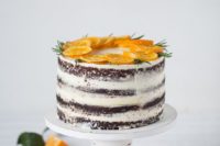 23 a semi naked wedding cake topped with fresh orange slices and rosemary is a tasty piece