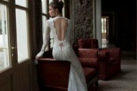 24 a lace wedding dress with long sleeves, a train and whimsy cutout back