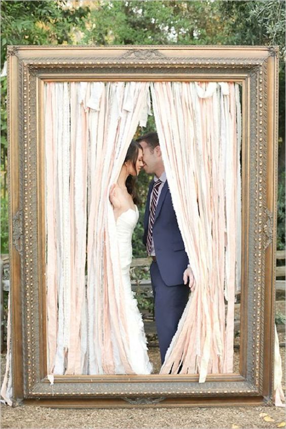 a large vintage frame with ribbons for a creative photo booth