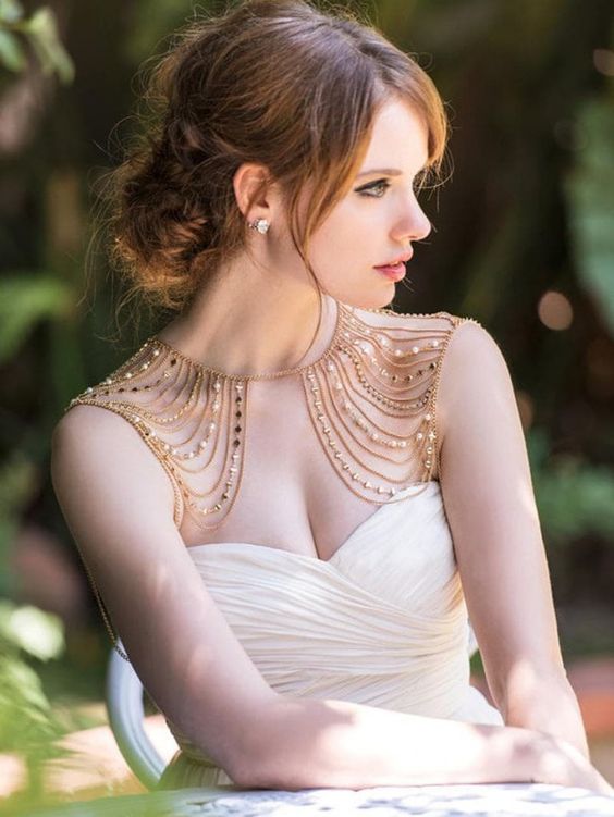 a fantastic shoulder jewelry piece with many rows of gold and pearls