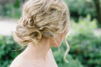25 a messy wavy and twisted updo for an effortlessly chic bride