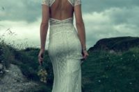 26 a sheath boho lace wedding dress with short sleeves, and a cutout back looks really wow