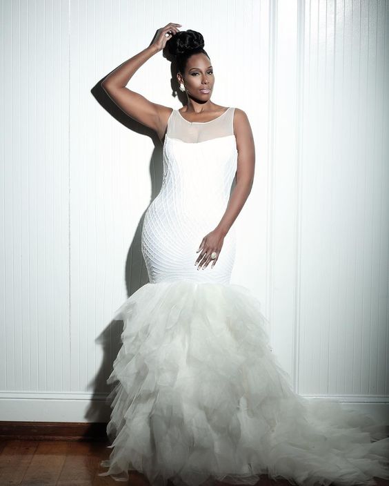 sleeveless mermaid wedding dress with an illusion neckline, a textural bodice and a ruffle tail