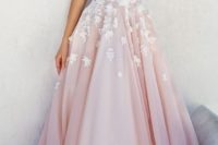 27 a pink wedding dress without sleeve, with a a covered plunging neckline and white lace appliques on the bodice and skirt