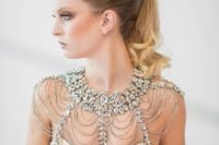 27 a statement bridal shoulder jewelry piece with lots of rows of beads and large rhinestones for a parkly bridal look