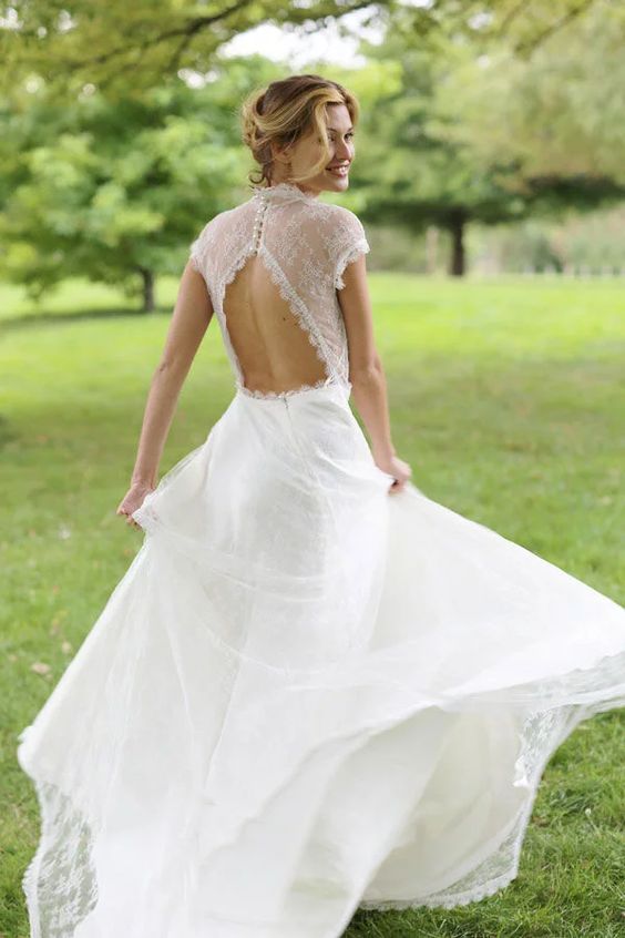 ethereal lace wedding dress with cap sleeves and a cutout back on pearly buttons