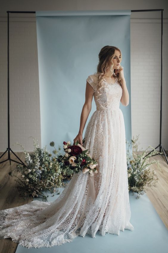 a textural A-line lace wedding dress with short sleeves and a scoop neckline