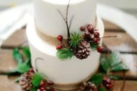 28 a winter wedding cake decorated with burlap, berries, pinecones and evergreens