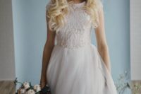 29 A-line wedding dress with a textural lace bodice with cap sleeves and a layered tulle skirt