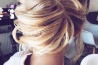 29 messy chignon hairstyle with a voluminous top and bangs for a modern wedding