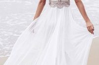 31 a beaded wedding dress with cap sleeves, an ethereal skirt and a cutout back