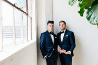 01 These dapper grooms got married in an industrial venue and turned it into a greenhouse