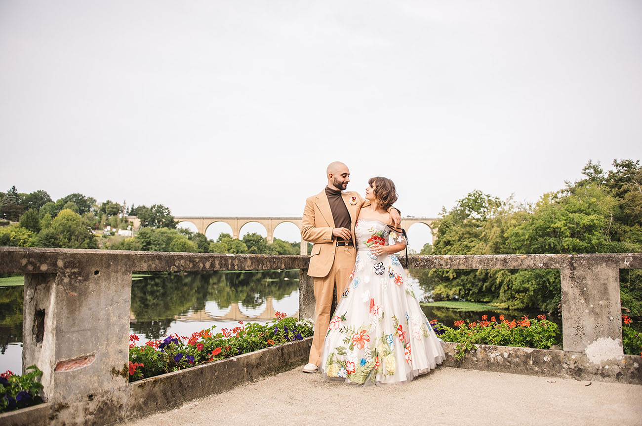 This couple got married in a French fort, with a floral wedding dress and lots of blooms from the whole neighborhood