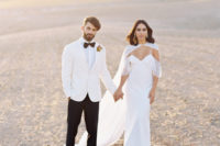 02 The first bridal look was done with a cold shoulder weddding gown and an airy cape, the groom was wearing a fresh take on a white tux