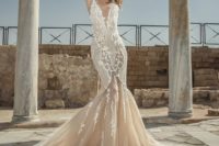 02 a fantastic mermaid wedding dress with an illusion plunging neckline, lace appliques and a train
