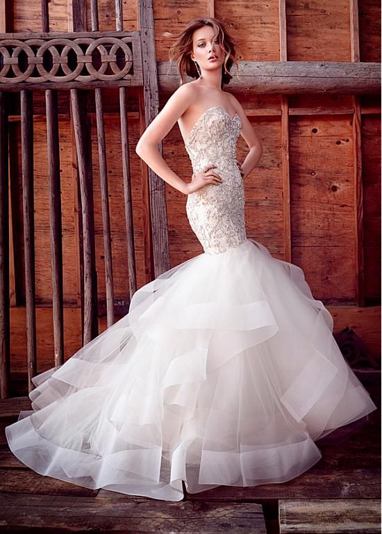 a strapless heavily embellished wedding dress with a ruffled tail looks very chic, refined and sexy