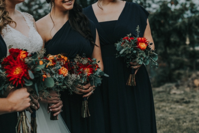The bridesmaids were rocking mismatched black maxi gowns