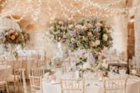 03 a beautiful canopy of lights for a barn wedding looks chic and brings enough light
