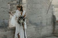 04 a boho lace wedding dress with a plunging neckline, bell sleeves, a high low skirt with a train for a boho look