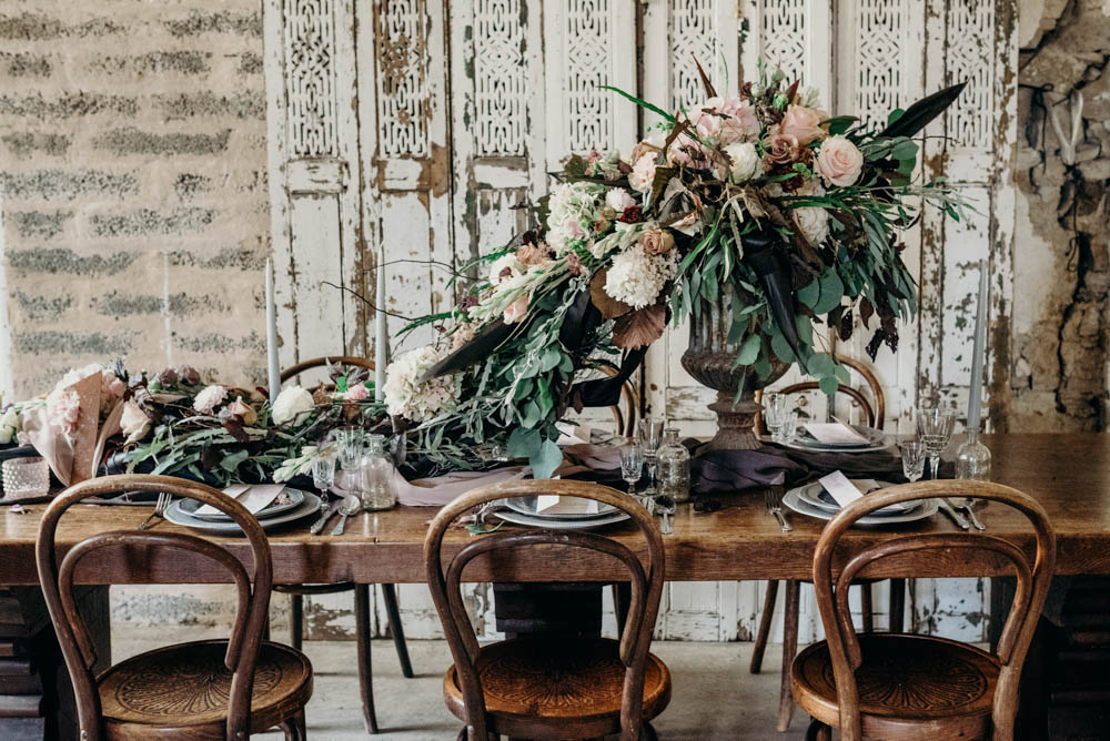 The wedding table was styled with refined fabrics like silk, a lush bloom cascading centerpiece that formed a table runner