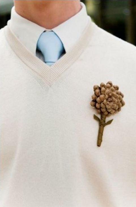 a creamy jumper over the shirt, a light blue tie and a pinecone boutonniere