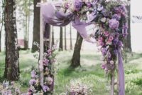 05 a fantastic floral arch with lilac draperies and lush blooms in purple shades on the corner and down