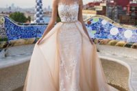 05 a peachy sheath wedding gown with an illusion bodice, white lace appliques and a large overskirt
