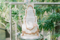 07 The first wedding cake was a watercolor botanical one with gold detailing and blooms