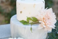 07 a modern wedding cake with a grey marbleized layer and a white gold leaf layer plus a large bloom