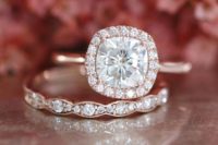 07 a rose gold engagement ring with a cushion diamond and a halo plus a matching wedding band with diamonds
