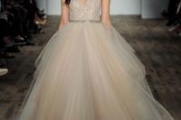 08 a champagne wedding dress with a lace bodice, spaghetti straps and a full layered skirt is accessorized with an embellished sash